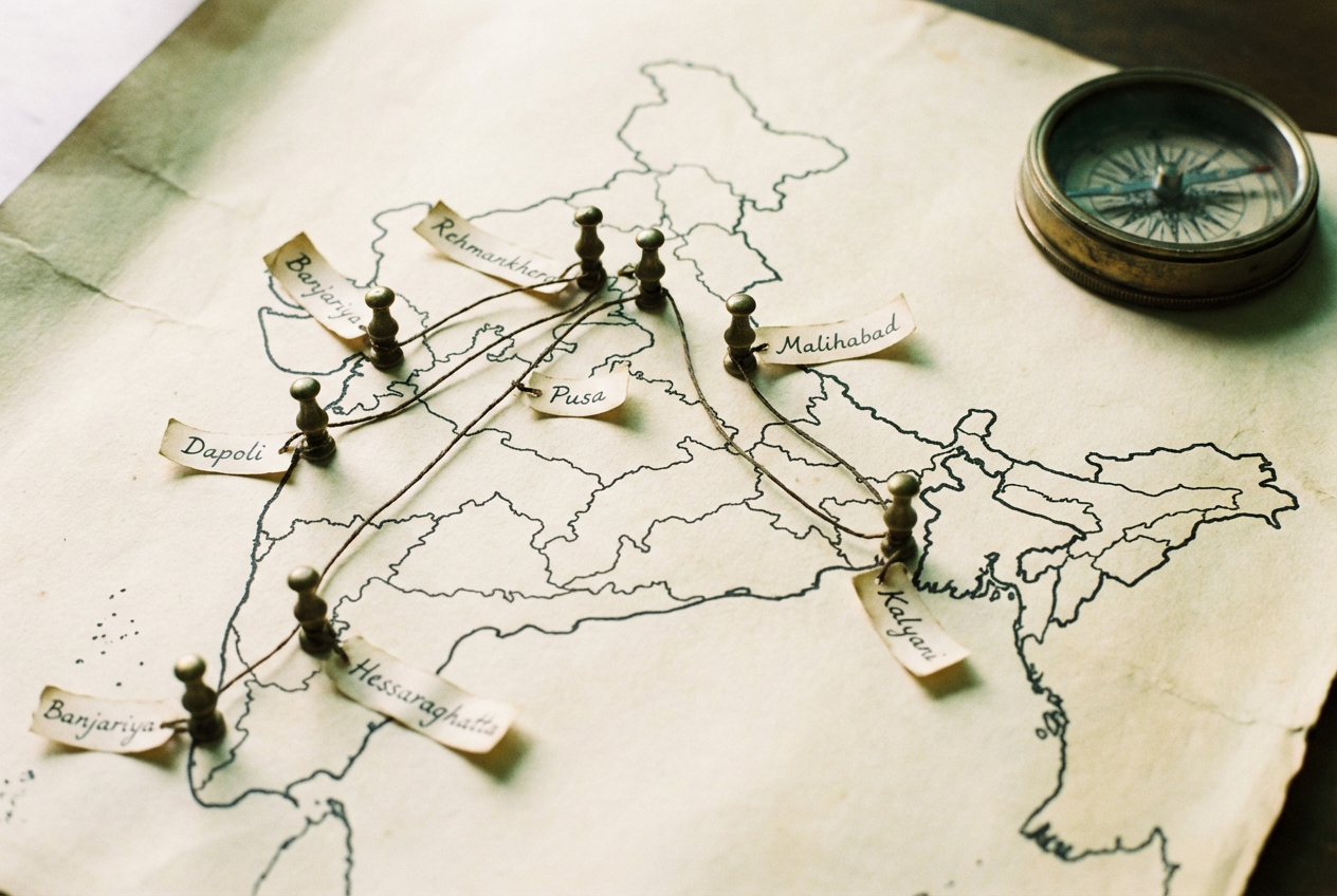 Hand-drawn India map pinned with brass and waxed thread, eleven nursery locations
